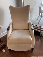 Front view of cream manual recliner chair showing overall condition and upholstery.