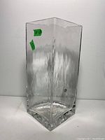 Full view of the tall clear textured Goebel glass vase with square shape and thick base.