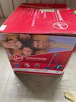 Original cardboard box for Hoover Whole House Floor Steamer, showing family image on side.