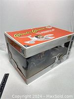 View of boxed Funko Pop Rides Wonder Woman The Invisible Jet edition #16 with some wear visible on box corners and edges. Ruler included for scale.