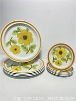 Set of 4 dinner plates and 4 side plates, all featuring the Summer Days floral pattern with yellow flowers and green leaves on white background with double yellow-orange border.