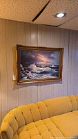 Full view of painting hanging on wall above sofa