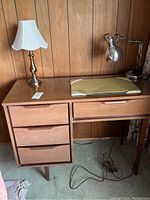 Desk with five drawers, showing surface and drawer fronts with some scratches.