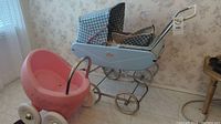 Vintage blue plaid stroller with padded basket and metal frame, shown from the side
