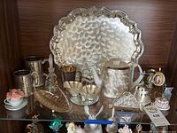 Photo of WMF Ikora silver plate serving tray and accompanying tea set and accessories displayed on a wooden shelf