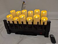 Front view of black metal electric fireplace with 12 flameless LED candles inside the grate.