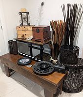 Overall lot including bench, trolley, storage containers, statues, and decorative items arranged in a corner