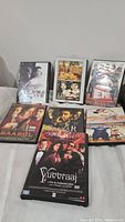 Photo of 7 Bollywood movie DVDs with visible covers including Black & White, The Gold Medal, EMI, Baabul, Sarkar, Yugraaj, and one unknown movie DVD case.
