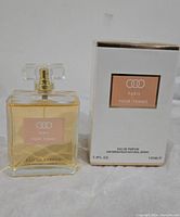 Photo showing 100ml Paris Pour Femme Eau de Parfum in glass bottle with clear rectangular cap beside original white and gold trimmed box.