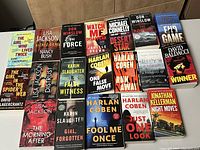 Photo displaying 19 paperback crime and police novels arranged in three rows, titles and authors clearly visible