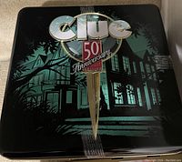 Top of the metal tin showing Clue 50th Anniversary Edition decorative design
