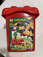 Red plastic LEGO container with label of Creator 4105 and 500 pcs