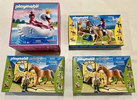 Four boxed Playmobil sets displayed on a white surface with labels visible: Princess 5476 featuring a swan carriage and three Country sets 5520 and two 5517 sets with horses and accessories.