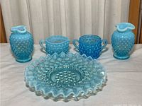 Full set of vintage blue hobnail glass including vases, a sugar bowl, creamer, and dish.