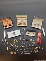 Cufflinks in original boxes along with loose cufflinks, tie pins, and clips