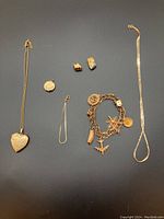 Overview of all jewelry pieces laid on black background