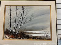 Full view of framed acrylic painting showing birch trees, earthy foliage, and a muted sky landscape on canvas.