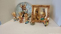 Full set showing five bunny figurines, decorative frame with bunny gardener, and collector plate with bunny holding handkerchief.