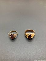 Top view of both rings showing oval amethyst stones