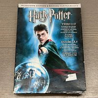 Front cover of the boxed DVD set showing Harry Potter pointing his wand with magical imagery, worn box visible