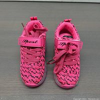 Front view of the pink wheelie kids shoes showing knit fabric and 'Sport' Velcro strap