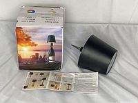 Box with image and packaging showing the dimmable lamp with bottle adaptor and included manual.