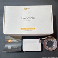 Box and one set of Luminoodle Click light strip with control unit and instructional leaflet.