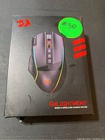 Front of Redragon Enlightenment gaming mouse box showing image of mouse with RGB lighting and Redragon branding.