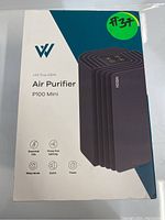 Box of the WeLov P100 Mini Air Purifier showing product name and features including essential oils, three fan settings, sleep mode, quiet operation, and timer.