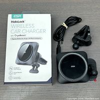 Photo of ESR HaloLock wireless car charger package, the wireless charger unit, a vent clip mount, and USB charging cable.