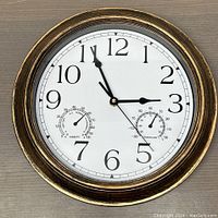 Front of the clock showing the dial with time, temperature, and humidity displays.