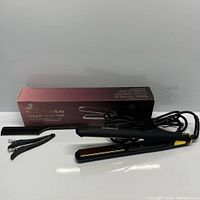 Hair straightener, comb, clips and box displayed against white background showing all components of the set.