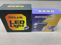 Two boxes of LED replacement lights for vehicles, showing OXILAM and AUTO1NE branding.