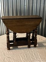 Closed barley twist drop leaf side table showing rectangular folded tabletop and twisted legs.