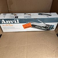 Box of new Anvil 14-inch tile cutter showing product image, brand, and description.