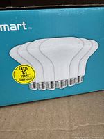 Box with illustration of five flat-top white LED bulbs, brand Smart, label states lasts 13 years or 15,000 hours.