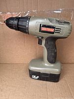 Front side view of the Craftsman cordless drill showing the 3/8 inch chuck, clutch dial, and rubberized grip with battery attached.