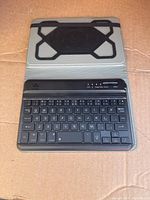 Full view of Power Pro Plus keyboard in protective case, showing compact design and rubberized surface.