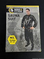 Front of the Series 8 Fitness Sauna Suit box showcasing a male model wearing the black suit. Highlights include lightweight, water resistant, tear resistant material, body heat trapping, and size M/L for waist 36-44 inches.