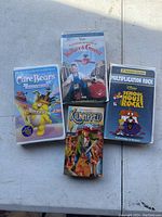 Lot of four VHS tapes including Care Bears, Wallace & Gromit, Kidnapped, and School House Rock! Multiplication Rock