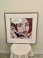 Front view of the framed Roy Lichtenstein print showing the comic style woman and visible cracked glass.