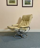 Front three-quarter view of the chair showing overall design, leather upholstery, and chrome frame.