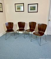 Four chairs arranged side by side against wall, showing overall set