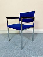 Front and side views of the blue fabric post modern armchair with chrome frame showing overall condition and vivid upholstery.