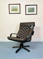 Front angled view of vintage IKEA Poem chair with button-tufted dark brown leather and black bent plywood armrests and base, showing overall condition and design.