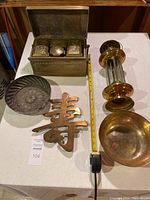 Overview of all items on white cloth with tape measure for scale