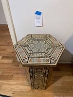 Front view showing hexagonal top and pedestal base