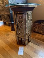 Full view of hexagonal inlaid wood side table with glass top