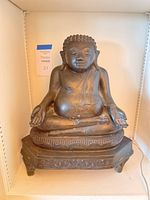 Front view of the Sitting Buddha bronze statue showing meditative pose and detailed base