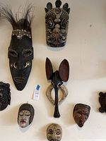 Overview of all six masks arranged on wall